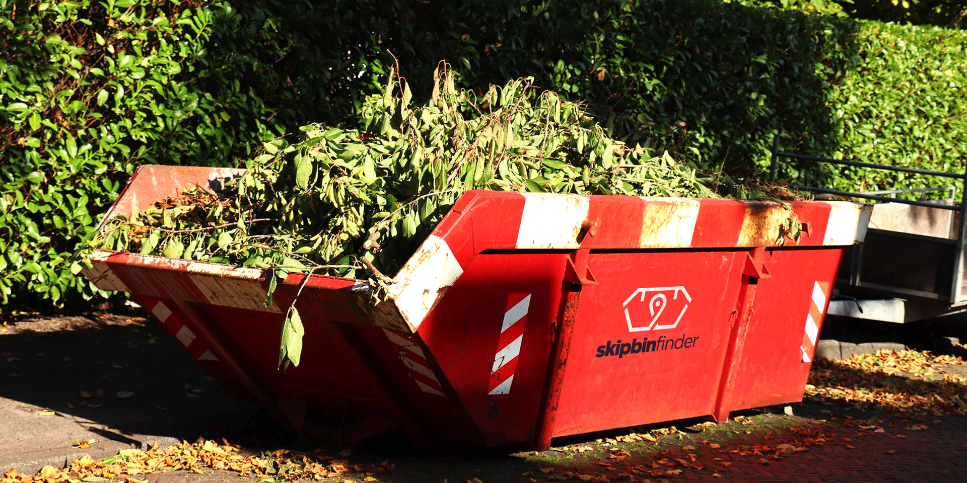 green heavy waste in skip bin