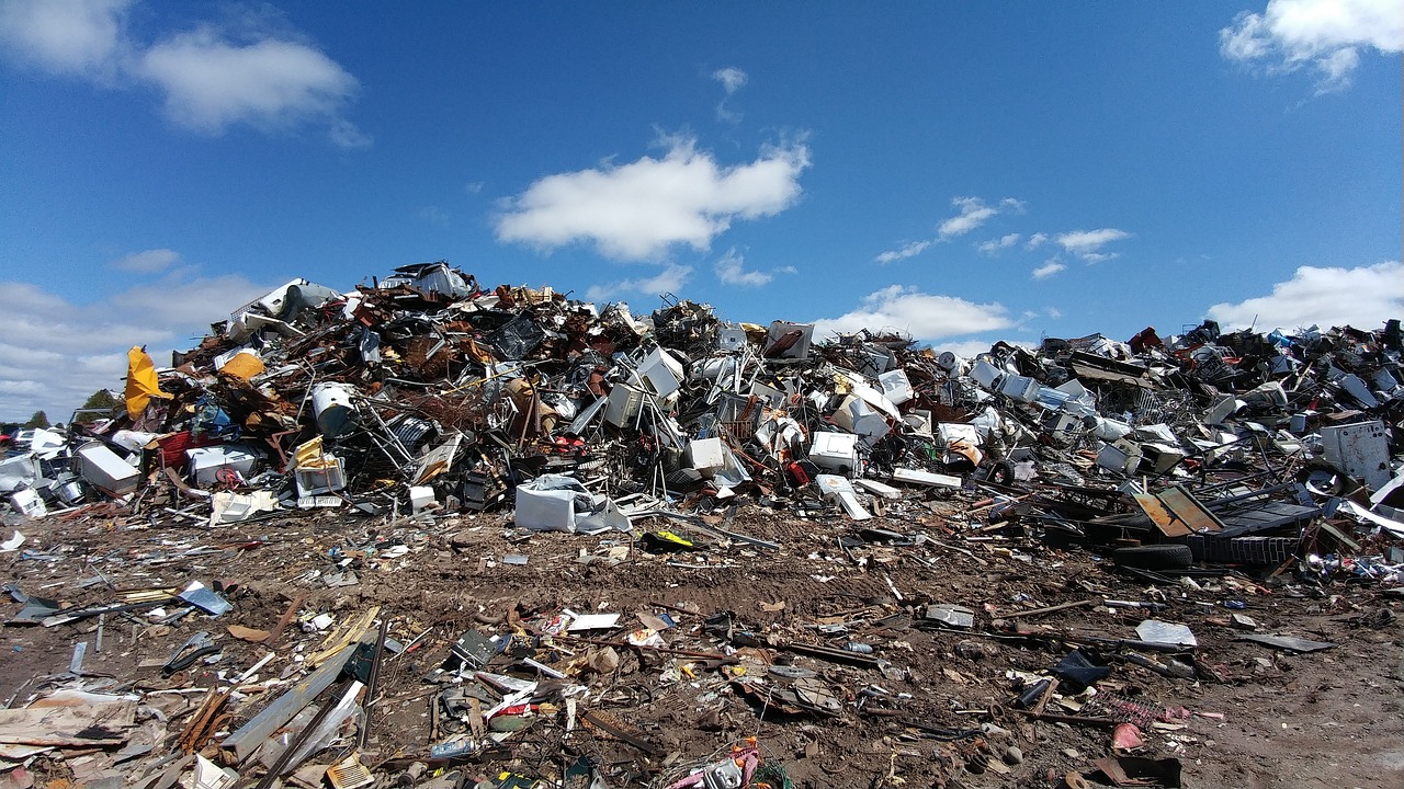 Landfill site with rubbish and blue sky